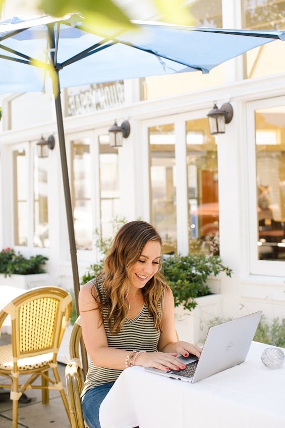 Becky Launder working at her laptop in a striped shirt
